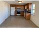 Functional kitchen featuring wooden cabinets, appliances, and tile flooring adjacent to a dining area at 3421 Allandale Dr, Holiday, FL 34691