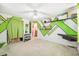 Bedroom with green geometric design on the walls, ceiling fan, and closet at 6920 Medlar Dr, New Port Richey, FL 34653
