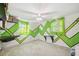 Bedroom with green geometric design on the walls, ceiling fan, and windows at 6920 Medlar Dr, New Port Richey, FL 34653