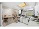 Bright kitchen features recessed lighting, window, white cabinetry, and tile flooring at 6920 Medlar Dr, New Port Richey, FL 34653