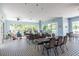 A well-lit community room features ample seating with tables and chairs, ceiling fans, and outdoor views at 8148 Ambersweet Pl, Land O Lakes, FL 34637