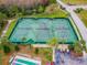 Aerial view shows tennis courts, surrounded by greenery and nearby parking, for community recreational use at 8148 Ambersweet Pl, Land O Lakes, FL 34637