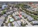 An aerial view of the home with community in the background and mature landscaping at 9250 Alcott Way, Trinity, FL 34655