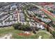 An aerial view of the home with nearby streets and golf course in the distance at 9250 Alcott Way, Trinity, FL 34655