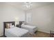 Bright bedroom with two twin beds, a ceiling fan and natural light from the window at 11243 Merganser Way, New Port Richey, FL 34654