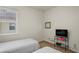 Bright bedroom with two twin beds and a TV stand at 11243 Merganser Way, New Port Richey, FL 34654