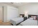 Bedroom featuring two beds with a ceiling fan and natural light coming in from the window at 11243 Merganser Way, New Port Richey, FL 34654