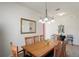 Dining area features a wood table, six chairs, overhead chandelier lighting, and a wall mirror at 11243 Merganser Way, New Port Richey, FL 34654