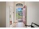 Foyer featuring a tile floor, an open red door and view of a garden in the front yard at 11243 Merganser Way, New Port Richey, FL 34654