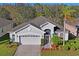 Charming single-story home with well-manicured landscaping, two-car garage, and inviting entryway at 11243 Merganser Way, New Port Richey, FL 34654