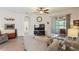Open living room featuring neutral tones, tile floors, recessed lighting, and a sliding door to the lanai at 11243 Merganser Way, New Port Richey, FL 34654