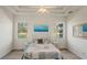 Serene main bedroom with a tray ceiling and views of the lush greenery and waterfront from its windows at 11243 Merganser Way, New Port Richey, FL 34654