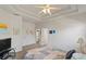 Comfortable main bedroom with a tray ceiling and neutral carpet featuring access to the ensuite bathroom at 11243 Merganser Way, New Port Richey, FL 34654