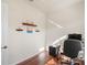 Office features hardwood floors, natural light from window, shelving and an office desk setup at 11243 Merganser Way, New Port Richey, FL 34654