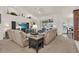 Bright living room with plush sofas, ceiling fan, and large windows showcasing a relaxing pool view at 12910 Oak Nut St, Hudson, FL 34667