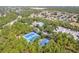 A view of a community pool and sports courts amidst trees and recreational vehicle parking at 13793 Dunwoody Dr, Spring Hill, FL 34609