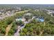 A full view of community swimming pool and tennis court with play area and parking through the tree tops at 13793 Dunwoody Dr, Spring Hill, FL 34609