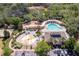 Aerial view of the community pool, playground, splash pad, and volleyball court surrounded by trees at 13793 Dunwoody Dr, Spring Hill, FL 34609