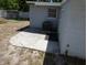 Home exterior showing backyard with concrete patio and an AC unit at 4011 W Mango Ave, Tampa, FL 33616