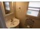 Powder room with vanity sink, mirror, and blinds on the window at 4011 W Mango Ave, Tampa, FL 33616