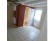 Bedroom with tile flooring, two doors, and access to bathroom at 4011 W Mango Ave, Tampa, FL 33616