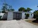 Cozy single story home featuring a screened in porch and tidy landscaping at 4011 W Mango Ave, Tampa, FL 33616