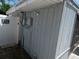 Exterior corner with white siding, showing electrical, gate and 'beware of dog' sign at 4011 W Mango Ave, Tampa, FL 33616