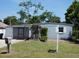 Modest home featuring a well-maintained front lawn and mailbox at 4011 W Mango Ave, Tampa, FL 33616