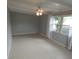 Well lit living room with beamed ceilings, ceiling fan and multiple windows at 4011 W Mango Ave, Tampa, FL 33616