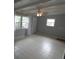 Bright living room with tile flooring, beamed ceilings and a ceiling fan at 4011 W Mango Ave, Tampa, FL 33616