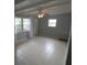 Bright living room with tile flooring, beamed ceilings and a ceiling fan at 4011 W Mango Ave, Tampa, FL 33616