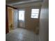 Bright, airy room with tile flooring, rear door, and window at 4011 W Mango Ave, Tampa, FL 33616