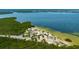 Aerial view of a waterfront park with sandy beaches, picnic areas, and lush vegetation at 5742 Meadowlane St, New Port Richey, FL 34652