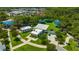 Aerial view of outdoor park with shade covers, green space, and nearby city buildings at 5742 Meadowlane St, New Port Richey, FL 34652