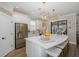 Bright kitchen island with a quartz countertop, bar seating, and modern pendant lighting at 11061 Egeria Dr, Odessa, FL 33556