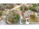 Aerial view of a home with a mature landscaped yard, two pools, and a driveway with multiple parked cars at 12529 Shadow Ridge Blvd, Hudson, FL 34669
