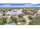 Breathtaking aerial view of the property with a large lake nearby in a desirable neighborhood at 12529 Shadow Ridge Blvd, Hudson, FL 34669