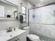 Bathroom featuring modern shower with glass door and decorative tile, as well as a sleek vanity and mirror at 12529 Shadow Ridge Blvd, Hudson, FL 34669