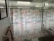 Small bathroom with a nautical-themed shower curtain, toilet, and sink at 12529 Shadow Ridge Blvd, Hudson, FL 34669