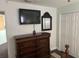 Bedroom featuring a dresser with a TV, a mirror, and a closet with paneled doors at 12529 Shadow Ridge Blvd, Hudson, FL 34669