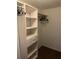 Walk-in closet with built-in shelving and drawers, offering ample storage and organization space at 12529 Shadow Ridge Blvd, Hudson, FL 34669