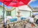 Charming home with a fountain and a red umbrella near the front entrance and a two-car garage at 12529 Shadow Ridge Blvd, Hudson, FL 34669