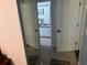 Hallway view leading to a bright bathroom with a vanity and mirror, through open double doors at 12529 Shadow Ridge Blvd, Hudson, FL 34669
