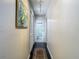 Hallway with a bathroom featuring a glass shower and dark wood flooring at 12529 Shadow Ridge Blvd, Hudson, FL 34669