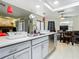 Kitchen featuring grey cabinets, stainless steel appliances and modern fixtures overlooking the dining area at 12529 Shadow Ridge Blvd, Hudson, FL 34669