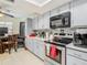 Modern kitchen features stainless steel appliances, ample counter space and gray cabinets at 12529 Shadow Ridge Blvd, Hudson, FL 34669