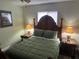Comfortable main bedroom with a decorative headboard, side tables, lamps and soothing wall colors at 12529 Shadow Ridge Blvd, Hudson, FL 34669