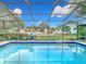 Refreshing pool with clear blue water, enclosed by a screen, perfect for enjoying sunny days at 12529 Shadow Ridge Blvd, Hudson, FL 34669