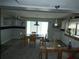 Bright dining room with sliding glass doors and updated flooring; a great space for meals and gatherings at 13618 Stacey Dr, Hudson, FL 34667