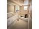This bathroom features tile flooring and a standard tub and shower with a vanity at 4515 Marine Pkwy # 102, New Port Richey, FL 34652
